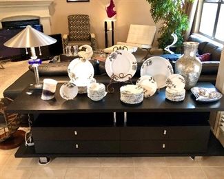 Modern black and chrome sleek TV console, I believe to be Cantoni.  Modern table lamp that matches floor lamp in other room.