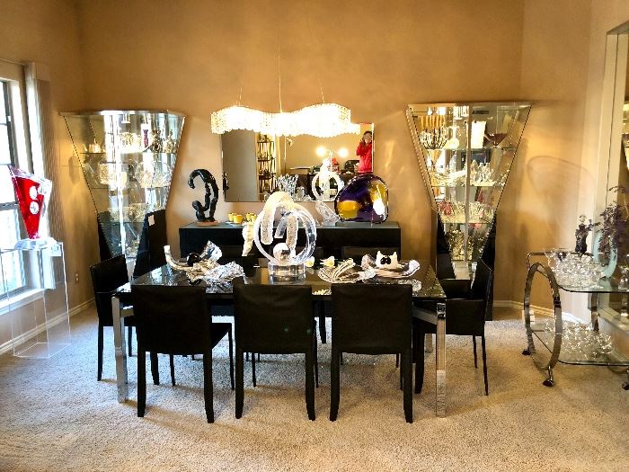 I believe Cantoni black glass & chrome extendable dining table with seating for 12.  Eight black leather Italian Cattelan dining chairs.  Fabulous.  Items reflect!