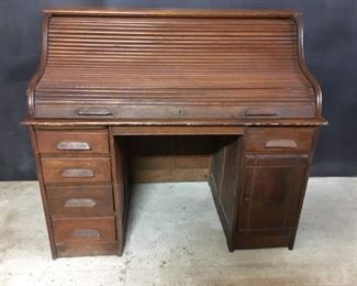 Roll top desk. Oak desk with “S" roll. Tambor works well. There is no “floor" inside the door. It is 52 inches wide and is 46.5 inches high.
