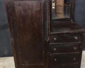 Chifferobe. This chifferobe is grained like oak. The mirror is beveled. It is 43.5 inches wide. From floor to top of mirror is just under 65 inches. It is 20 inches deep. Needs some repair.
