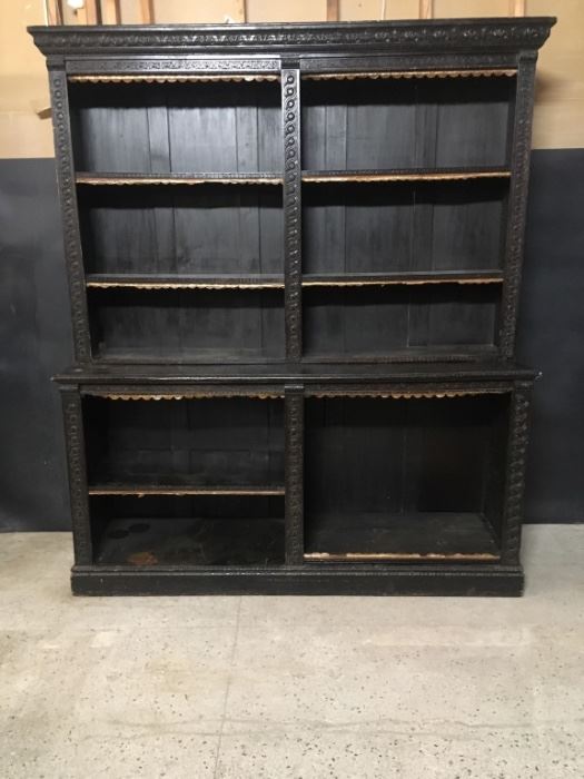 Carved oak shelf unit. Hand carved oak with Jacobean dark stain. It is about 74.5 inches wide. Total height is about 68.5 inches. The base is 38 inches high. The upper part is about 11 inches deep. The lower part is about 21.5 inches deep.