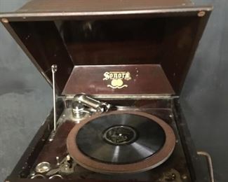 Record player. Sonora record player. The head of the sound arm is missing. The the spring doesn’t seem to wind up. The cabinet is in good shape.