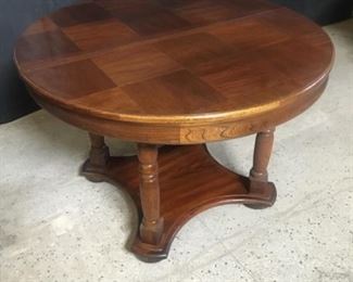 Parquet top dining table with four legs. The wood looks like oak with a pecan stain. Top is about 42.5 inches across.