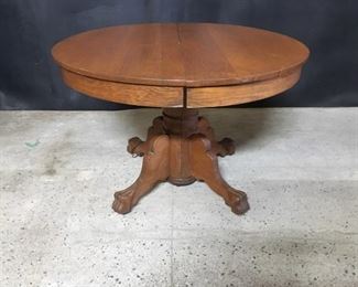 Round oak table. Vintage oak dining table. The top is about 42 inches across. It has claw feet. Center pedestal opens and there is a center leg. There are no leaves with it.