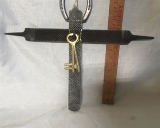 Cross for a cowboy. This cross is made from three
hoof rasps and a horseshoe. It has two keys to signify that the cross is the key to the kingdom of God. As you can see, it is about 17 inches tall.