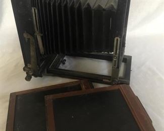 View camera. Body of antique large format view camera. Bellows has some breaks in it. There are two film carriers.