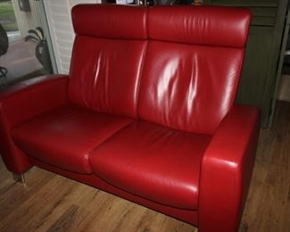 $500. Stressless, back reclining red leather love seat, "Arion". 54 inches wide