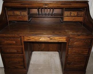 $150. Roll top desk with filing drawers and plenty of other storage areas. 54x29x45.