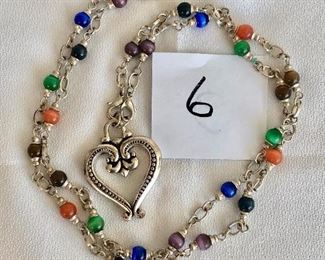 $12.   Colorful costume necklace with rhodium plate heart and chain with colorful beads.