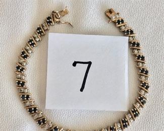 $40.  Sterling silver tennis bracelet with diamond chips and sapphires.   7.5” long. 