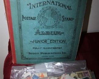 $45. Stamp collection album and bags of stamps.