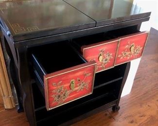 Asian inspired bar hutch. Has 3 drawers and two shelves.