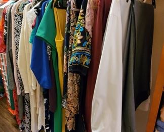 Large walk in closet full of clothes and shoes