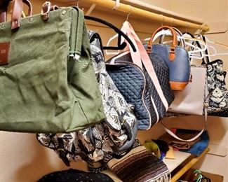 Large walk in closet full of clothes and shoes and bags