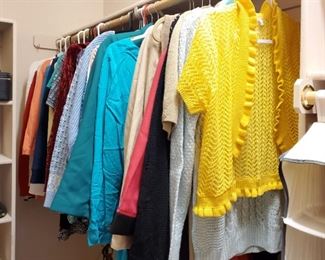 Large walk in closet full of clothes and shoes