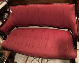 Antique settee with red upholstery
