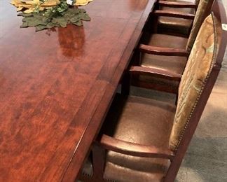 This extra large consigned dining table has 2 leaves and 12 arm chairs.