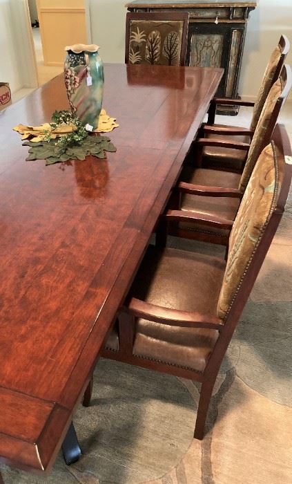 This extra large consigned dining table has 2 leaves and 12 arm chairs.