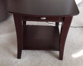 $150 each, two available.   Enclave rectangular end table                                                                                                       
26" D x 22" W x 24" H        Features sleek, rounded edges, crafted from elite poplar solids and cherry veneers.   Has a drawer for storage.