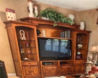 Walter E Smithe entertainment center with side display shelves-fits a 55" TV- this photo is of actual unit, from the owners photos. Pieces are currently disassembled which makes for easier moving!