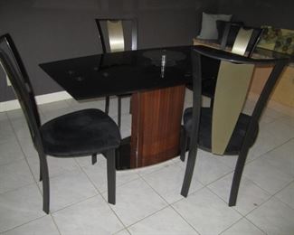 GLASS TOP TABLE WITH HIDDEN LEAF AND MATCHING LAZY SUSAN AND 4 CHAIRS IN GREAT CONDITION