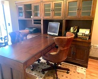Double sided desk with credenza, cabinets, shelves, measures approximately 9’4” wide by 7’2”