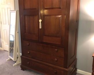 This modern KY Cherry armoire three large drawers below double doors that an abundance of storage.  Made by Colonial Furniture craftsman.   Excellent condition, with a finish as smooth as silk. 