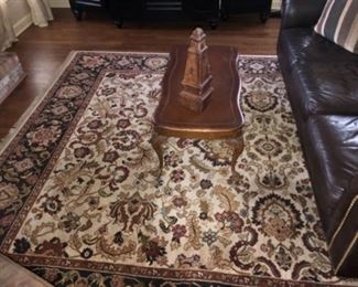 wool 8’8”x 12 area rug with brown tones. Brown leather Pelle sofa by Drexel.  Mahogany with leather inlay and carved ball and claw leg coffee table. 