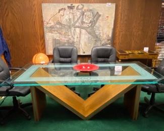Lot 5001.  $750.00  Glass Conference Table. w/oak "M" Base and Chrome Accents. So much Potential. 84"L x 42"W x 29.5"H w/ 3/4" thick glass. Very sturdy and glass in etched around the edge of the glass. Chairs are sold separately in next lot. Chairs are sold separately in next lot.