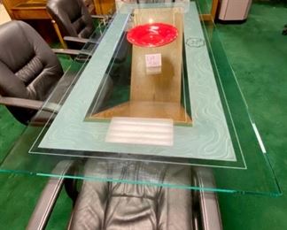 Lot 5001.  $750.00  Glass Conference Table. w/oak "M" Base and Chrome Accents. So much Potential. 84"L x 42"W x 29.5"H w/ 3/4" thick glass. Very sturdy and glass in etched around the edge of the glass.  Chairs are sold separately in next lot.