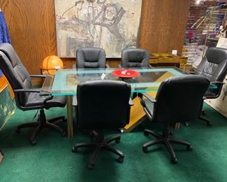 Lot 5001.  $750.00  Glass Conference Table. w/oak "M" Base and Chrome Accents. So much Potential. 84"L x 42"W x 29.5"H w/ 3/4" thick glass. Very sturdy and glass in etched around the edge of the glass. Chairs are sold separately in next lot.