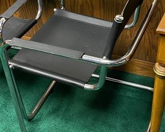 Lot 5009  $1,400.00  Set of 4 Effezeta Italian Black and Chrome Cantilever Style chairs.  Made in Italy, super mod, real cool. Slings are Leather as well as the  leather arm rests.  Chrome base is very solid. 22.5" W  x 30" H x 15" seat height x 23" front to back. Only 1 Set.