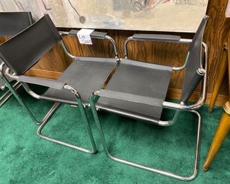 Lot 5009  $1,400.00  Set of 4 Effezeta Italian Black and Chrome Cantilever Style chairs.  Made in Italy, super mod, real cool. Slings are Leather as well as the  leather arm rests.  Chrome base is very solid. 22.5" W  x 30" H x 15" seat height x 23" front to back. Only 1 Set.