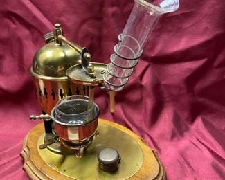 Lot 5024.  $95.00  Very Unique Miniature Brass Distiller w/ wooden base.  12" W x 9" D  x 13" H.  Very unique and  cool piece for a bar display.   