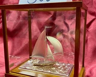 Lot 5026. $60.00 Silver-plated sailboat by Takehiko in Wood and glass case.  6" H  x 6.8  L x  4" W.  Very Good condition overall