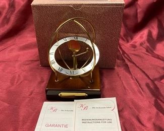Lot 5052. $20.00  KB Space clock mahogany base. Made in West Germany. 4" D x 4" W x  6" H. Very cool clock.  Just sold these at our last sale...  Only one left.