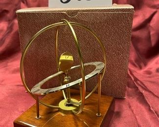 Lot 5052. $20.00  KB Space clock mahogany base. Made in West Germany. 4" D x 4" W x  6" H. Very cool clock.  Just sold these at our last sale...  Only one left.