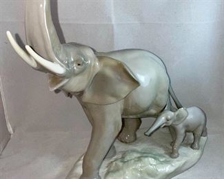 Lot 5031.   $175.00   Lladro Porcelain #1151  "Two Elephants" Mother and Calf. Figurine.  10" W base, 12" H  Mom and  2" H for Calf. Really a cool piece.  Sold on eBay for up to $275.00.  Scroll down to Lot 5031 for additional photos.