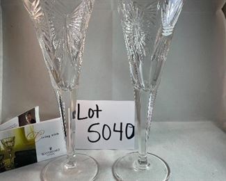 Lot 5040. $50.00 Pair of Waterford Crystal Millennium Champagne Flutes 9.25" x 3.25"at the top. No box. One flute is the Universal Wishes Flute, it includes all 5 of the toasting themes of the Millennium collection, the other flute is happiness. 
