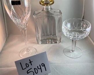 Lot 5049. $190.00 Beautiful Ralph Lauren Crystal Edward Gold Decanter (9" H  x 4.75" W  x  2.5" D) this decanter alone sold on ebay for $249 in December. Also included are these 2 Waterford glasses- one Waterford Marquis Wine Glass (9.24" H), and one Waterford Coupe/Sherbet Glass (possibly Kildare pattern), (5.25" W x 3.75" diameter). No boxes.