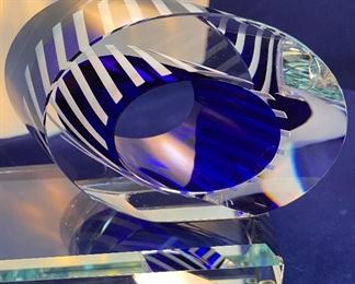 Lot 5082.  $275.00    2 Gorgeous Pieces of Harrie Glass, the first is a  STUNNING Flame in blues, purple, and clear 9.5" H  x 3" W.  The second piece is a blue and clear Ellipse on base 6" Wx 3.25" D. I was able to find these same flame online fetching $400 and an ellipse without the base for $165. So our price is a STEAL for both pieces.