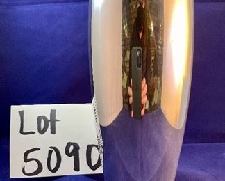 Lot 5090  $20.00 Nambe' Ellipsis Vase 8" H. Designer: Karim Rashid(6060). (13 Total, 1 has no box, 12 boxed) are available. Measures 8" H.   Recognized for its award-winning designs for more than 60 years, Nambé’s commitment to timeless beauty, artistic integrity and uncompromising quality is evident in the brand’s collection of serveware, barware, home décor and gift items. 