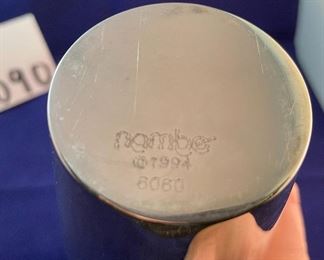 Lot 5090  $20.00 Nambe' Ellipsis Vase 8" H. Designer: Karim Rashid(6060). (13 Total, 1 has no box, 12 boxed) are available. Measures 8" H.   Recognized for its award-winning designs for more than 60 years, Nambé’s commitment to timeless beauty, artistic integrity and uncompromising quality is evident in the brand’s collection of serveware, barware, home décor and gift items. 