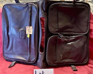 Lot 5115.  $85.00. Brown Leather "The Shoe Horn" Saddle Bag. Used to go over a Suitcase for additional storage. 2 zipper pockets and 1 zipper compartment. 16" W  x 12" H.  In addition we have included a  solid brass shoe horn. 16" W  x 12" H