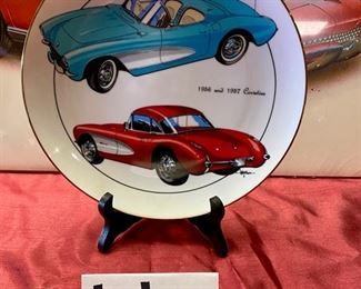Lot 5121. $25.00. 1991 Hugo Prado Silver Salute Poster of a 1966 Corvette "427" Turbo-Jet (in plastic, but there seems to be a little water damage in the upper left corner, once framed and matted this wouldn't be noticeable) and a commemorative plate of a 1956 & 1957 Corvette from World Wide Line (Style: 694) its a sample. Plate Stand Not included.  25" W  x 19" H print. Plate: 10" Diameter 