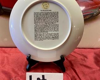 Lot 5121. $25.00. 1991 Hugo Prado Silver Salute Poster of a 1966 Corvette "427" Turbo-Jet (in plastic, but there seems to be a little water damage in the upper left corner, once framed and matted this wouldn't be noticeable) and a commemorative plate of a 1956 & 1957 Corvette from World Wide Line (Style: 694) its a sample. Plate Stand Not included.  25" W  x 19" H print. Plate: 10" Diameter 