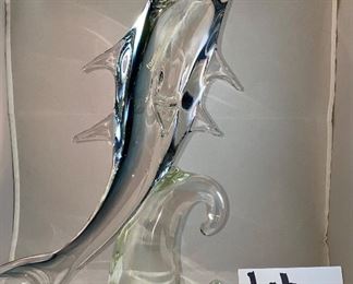 Lot 5140. $60.00 Murano Glass Dolphin by Formia Vetri Di Murano. Beautiful, clear and blue. Sold as is, has a chip in one of the fins, but it was too cool to not include. 16" H  x 10" D x 5"W   Has sold for $195 online, so our slightly injured dolphin is well-priced, as he is GORGEOUS.