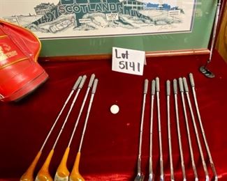 Lot 5141. $75.00. History of Golf Framed Art. Hand Signed C. Burton 1988. Signed and Numbered,  #944/1000. AND Novelty MINIATURE Golf clubs and Cart w/steel shafts Including 4 woods, Irons, Sand wedge and putter and a bag on wheels. Balls too.  Scotch Whisky or Old Andrews label on the bag.  Nice addition to your man cave!