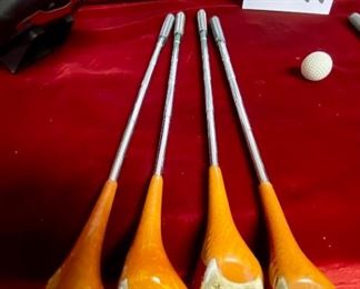 Lot 5141. $75.00. History of Golf Framed Art. Hand Signed C. Burton 1988. Signed and Numbered,  #944/1000. AND Novelty MINIATURE Golf clubs and Cart w/steel shafts Including 4 woods, Irons, Sand wedge and putter and a bag on wheels. Balls too.  Scotch Whisky or Old Andrews label on the bag.  Nice addition to your man cave!