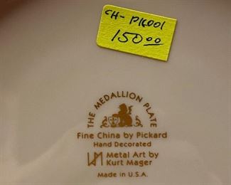 Lot 5145. $80.00. Very Cool Chicago Lot. T. Chamness Landmark Ink Art (18.5" H  x 14.25" W  has a plexiglass front, probably needs a piece of glass in there). A Wooden Medallion of Chicago Landmarks by Kurt Mager (6.25" diameter ).  A City of Chicago Crest clock with a hinge to reveal a clock (3"). The Medallion Plate by Pickard w/metal art by Kurt Mager (same art as the wooden medallion. 